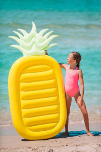 Rear view of woman standing on beach