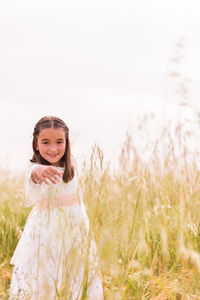 Smiling girl standing in field