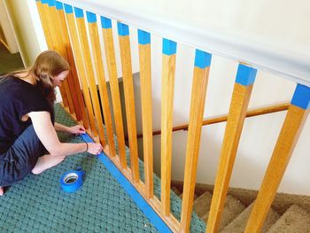Woman taping the banister