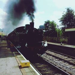 Train on railroad tracks against sky