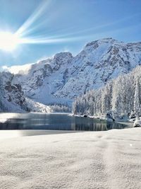 Scenic view of snowcapped mountains by lake against sky