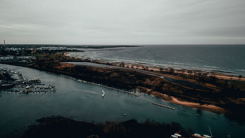 High angle view of sea and cityscape against sky