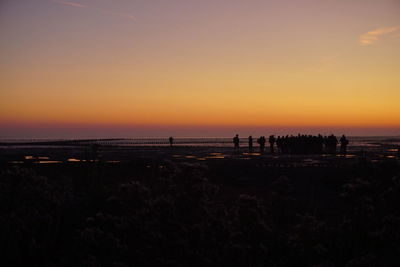 Scenic view of beach against sky during sunset