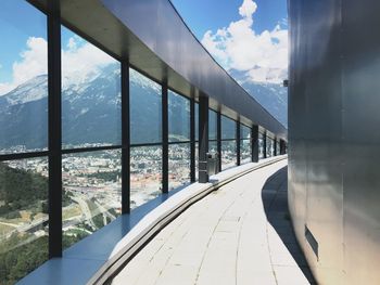 Bridge over sea against sky seen through glass window