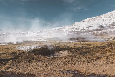 Hot spring on landscape against sky