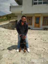 Full length portrait of young man with horse