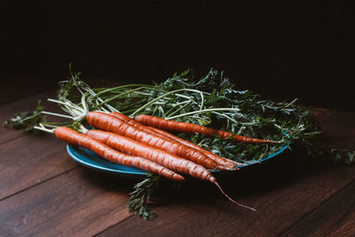 Close-up of vegetables on table against black background