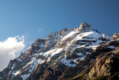 Low angle view of snowcapped mountain against sky