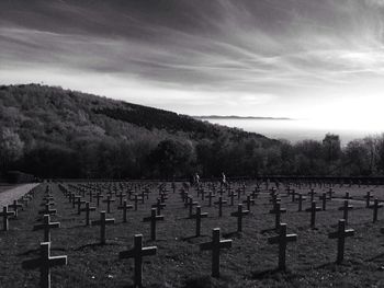 Cemetary against cloudy sky