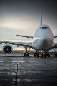 Airplane on runway against sky