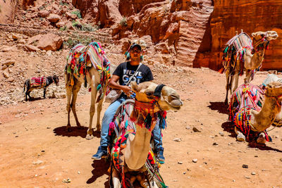 Full length of man with umbrella on sand