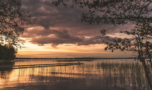 Scenic view of lake against sky during sunset