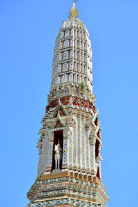 Low angle view of bell tower against clear blue sky