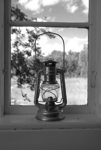 Close-up of lantern on window sill