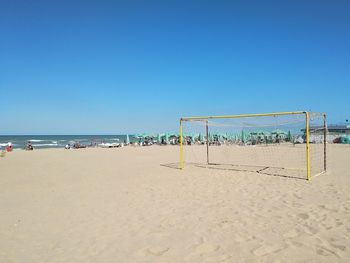 Scenic view of beach against clear blue sky