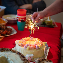 Cropped hand of person preparing food on table