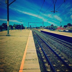 Railroad tracks against blue sky