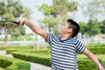 Boy playing badminton at park