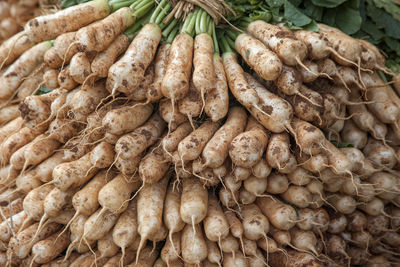 Full frame shot of daikon radish for sale at market stall