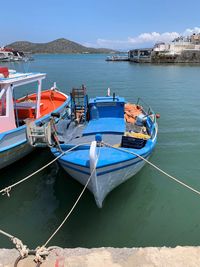 Boats moored on sea against sky