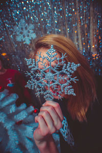 Portrait of woman holding plant