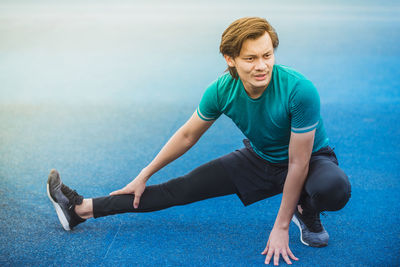 Young man exercising at stadium