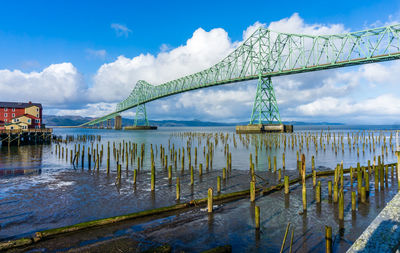 A view of the astoria-megler bridge that spans the columbia river. old pilings in the forground.