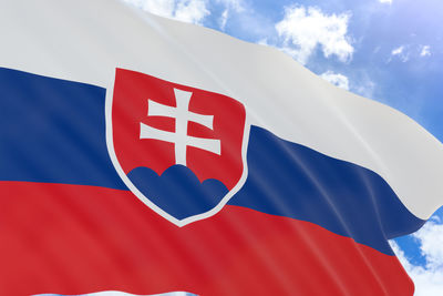 Low angle view of flag against blue sky