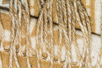 The texture of white woolen yarns twisted with brown ornament closeup