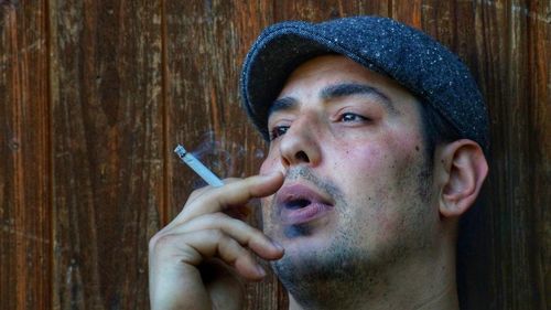 Close-up of man smoking cigarette