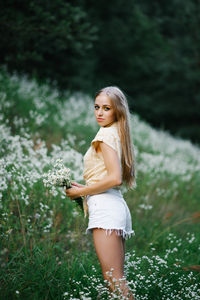 Portrait of a sweet gentle girl in a field of white flowers person