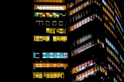 Low angle view of illuminated skyscraper at night