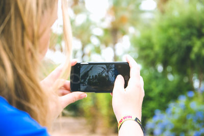 Rear view of woman using mobile phone