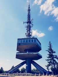 Low angle view of communications tower against sky