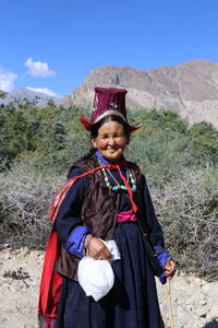 Portrait of smiling young man standing on land