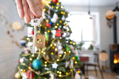 Cropped hand of woman holding christmas decorations