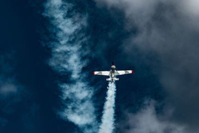 Low angle view of airplane flying against sky