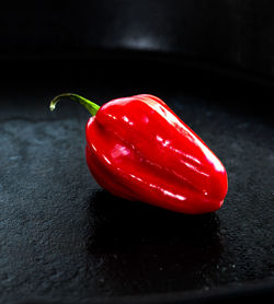 Close-up of red chili peppers on table