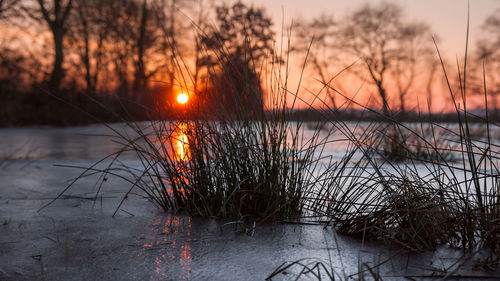 Scenic view of lake against sky during sunset