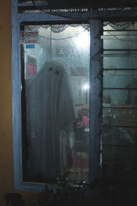 People standing by window in building