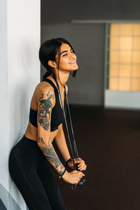 Side view of woman exercising at gym