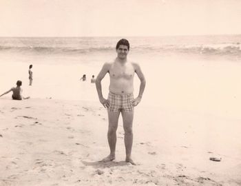 Portrait of shirtless man standing on beach