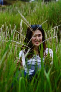 Portrait of smiling young woman in field