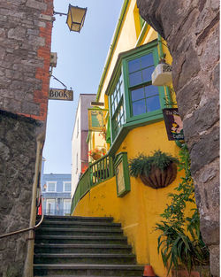 Low angle view of yellow building against sky