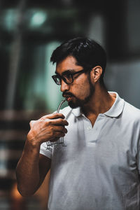 Young man drinking glasses outdoors