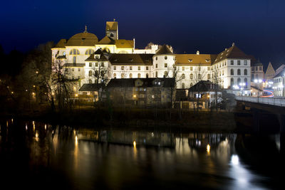 Reflection of buildings in city at night