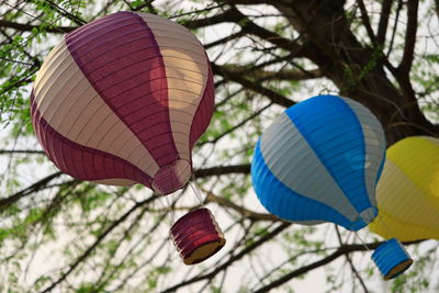 Low angle view of lanterns hanging against sky