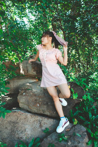 Woman looking at tree against plants
