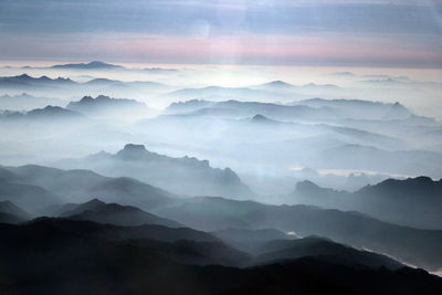 Scenic view of mountains against cloudy sky