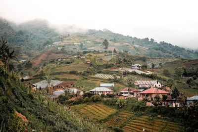 High angle view of houses on field against sky